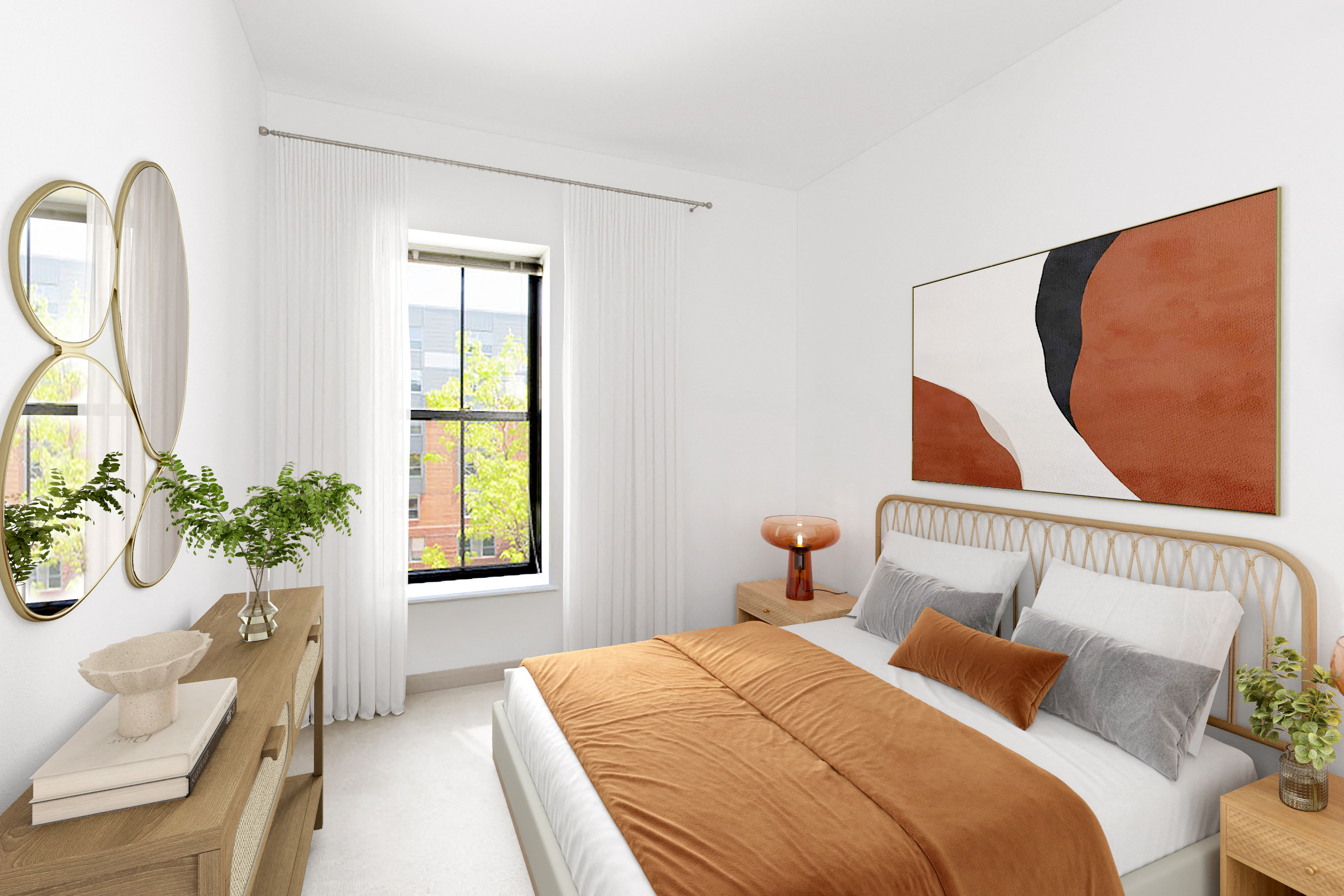 a bedroom with white walls and a bed with orange pillows