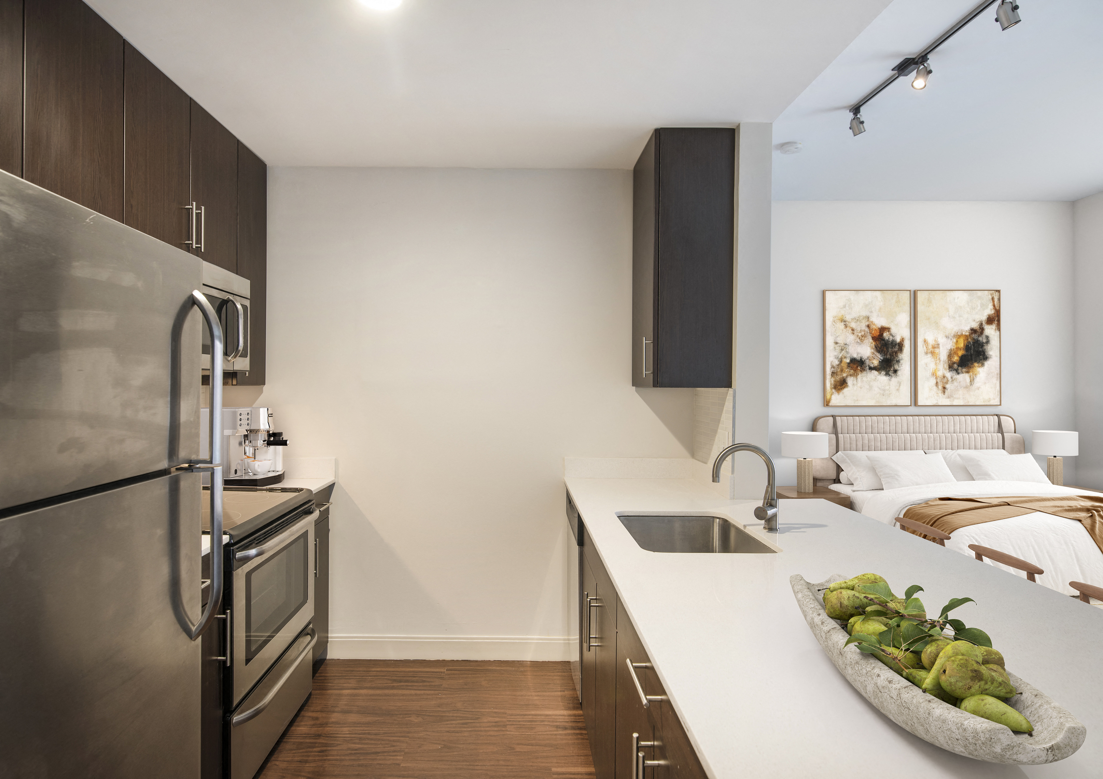 a kitchen with stainless steel appliances and a counter top with a bowl of fruit