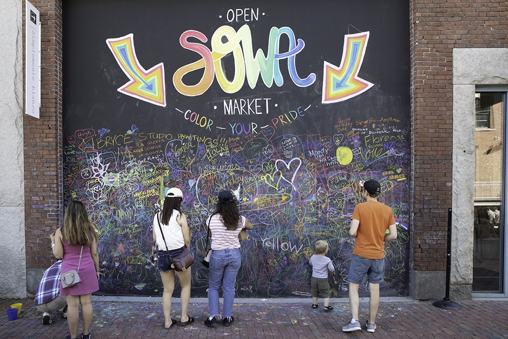 a group of people looking at graffiti on a wall