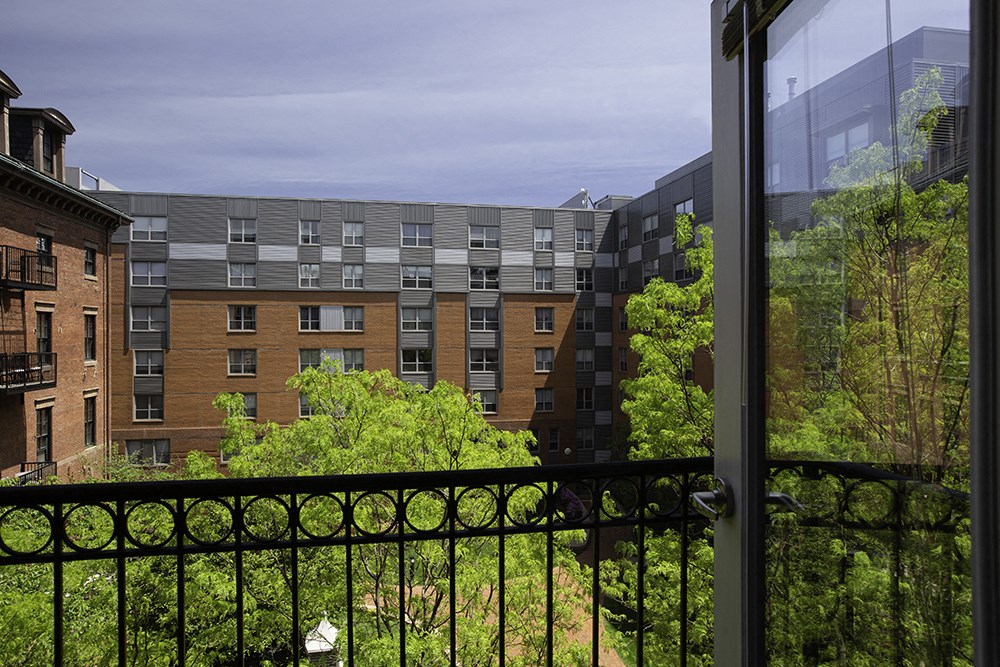 a balcony with a view of trees and buildings