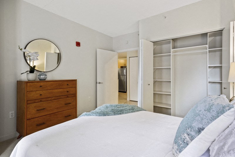 a bedroom with a large bed and white closet doors