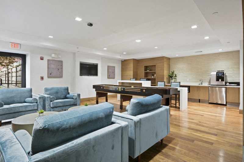 a living room with couches and chairs and a table with a chessboard