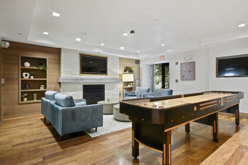 a game room with a pool table and a tv