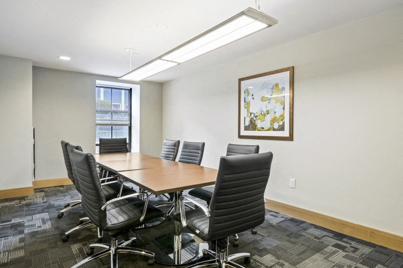 a conference room with a wooden table and chairs