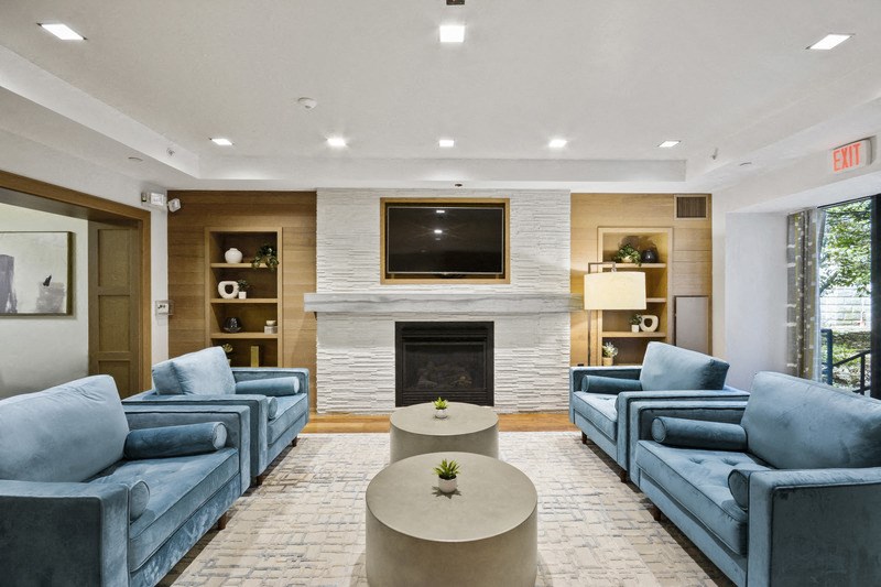 a living room with blue couches and a fireplace