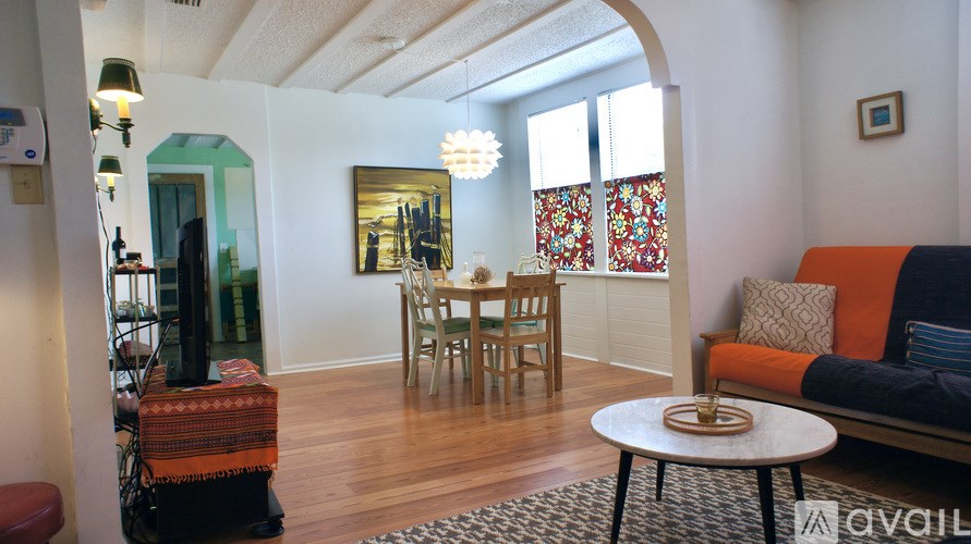 A living room with a sofa, a table, and a television.