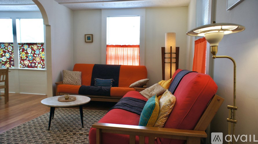 A living room with a sofa and a table.