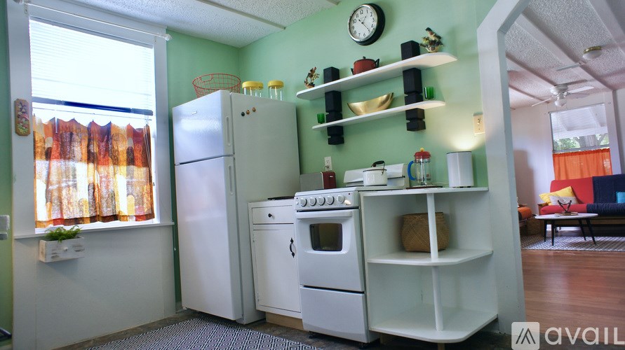 A kitchen with green walls and white appliances.