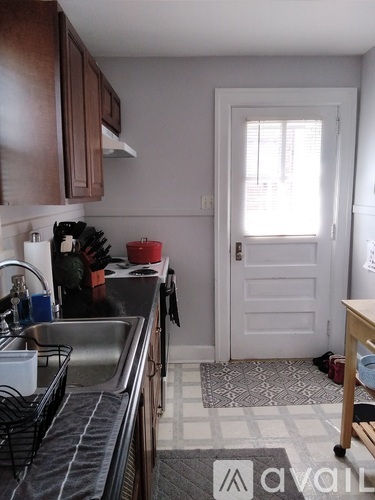 A kitchen with a sink and a window.
