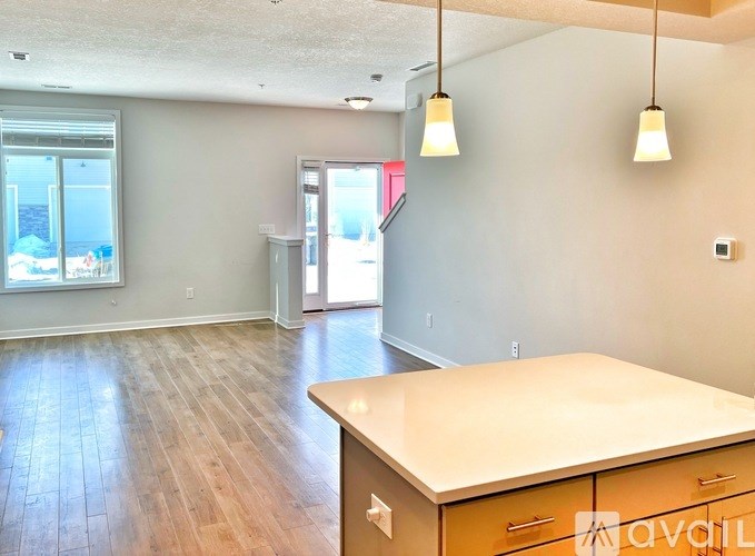 A room with a desk and a window overlooking the beach.