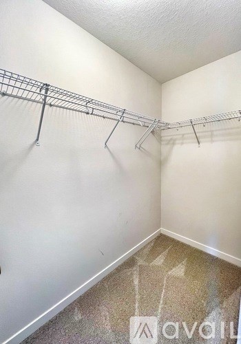 A white wall with a metal rack on it.