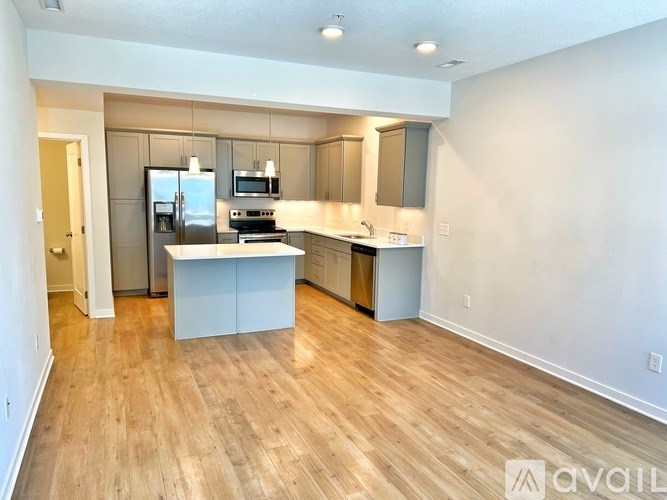A kitchen with a refrigerator, oven, and microwave.