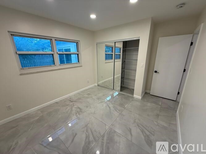 A room with a tiled floor and a sliding glass door.