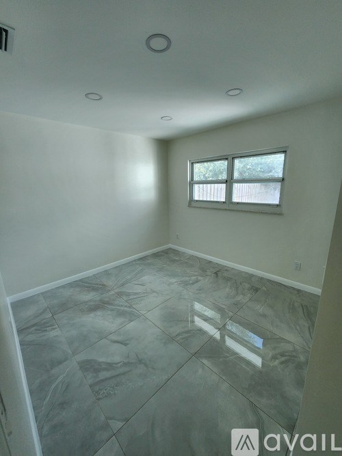 A room with a tiled floor and a window.