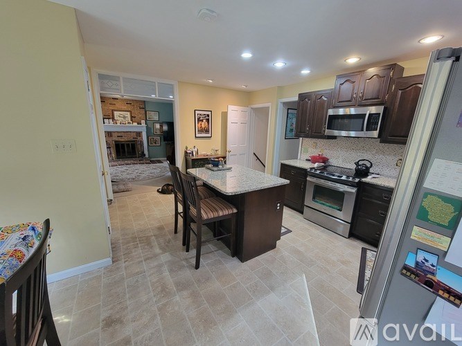 A kitchen with a table and chairs in the middle of the room.