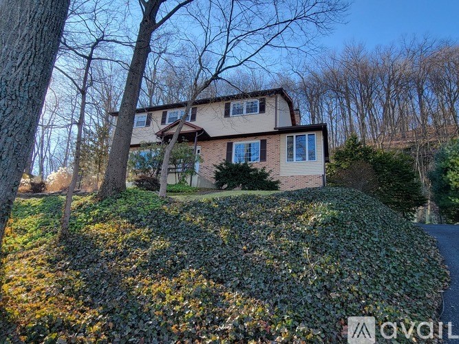 A house with a well-maintained lawn in front.