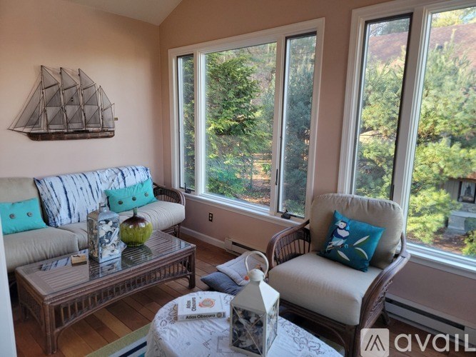 A living room with a sofa, chair, and coffee table.