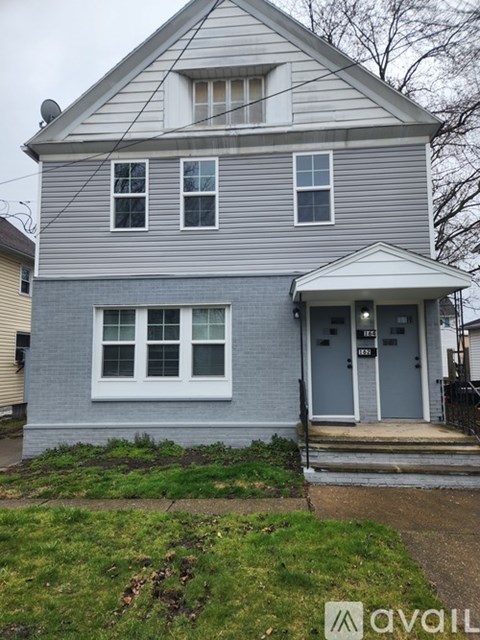 A two-story house with a grey and white exterior.
