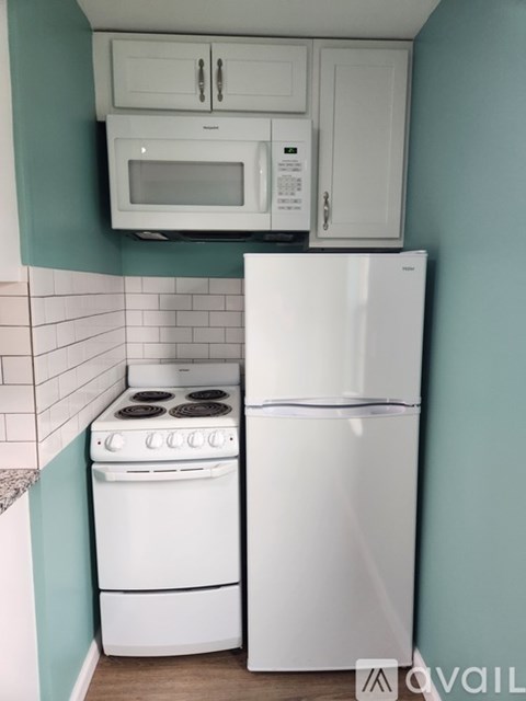 A white refrigerator and stove in a kitchen.