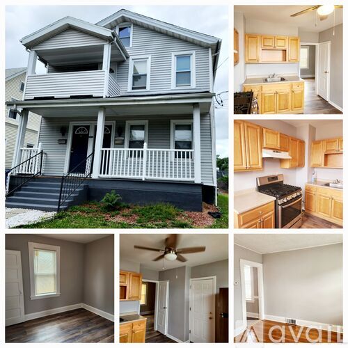 A house with a front porch and a kitchen with wooden cabinets.