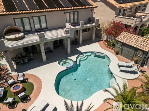 A large house with a pool in the backyard.