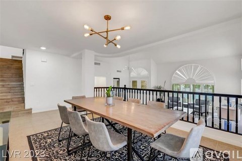 A dining room with a wooden table and chairs.