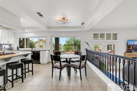 A modern kitchen with a dining table and chairs.