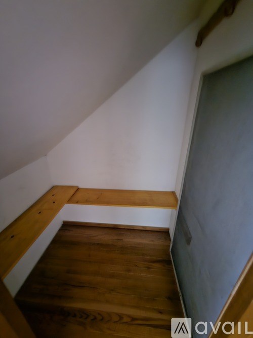 A wooden staircase with a white railing.