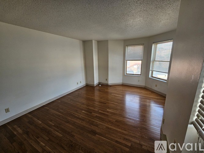 A room with wooden floors and white walls.
