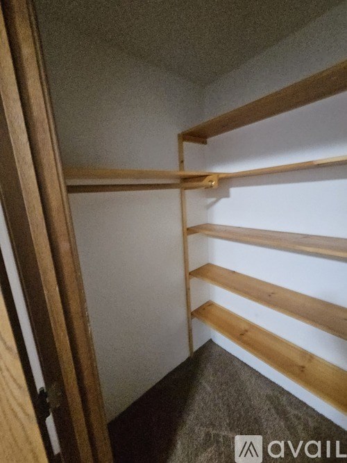A wooden staircase with a carpeted floor.