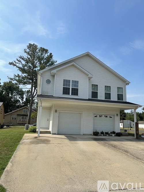 A two-story house with a garage is shown in the image.