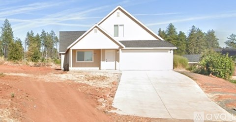 A house with a white garage door is for sale.