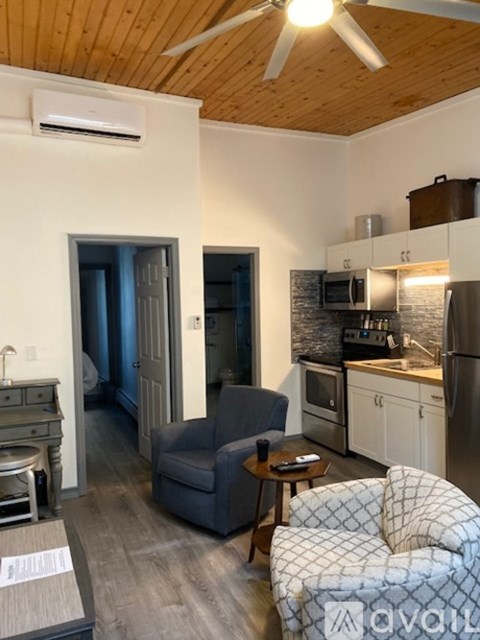 A living room with a grey couch and a wooden table.