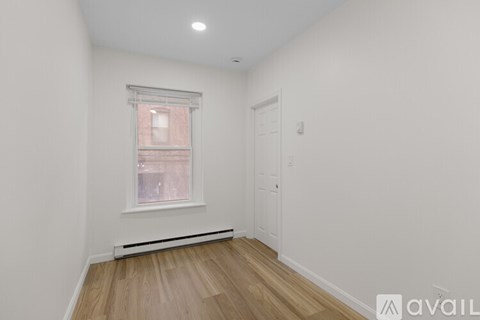 A room with a window and a door.