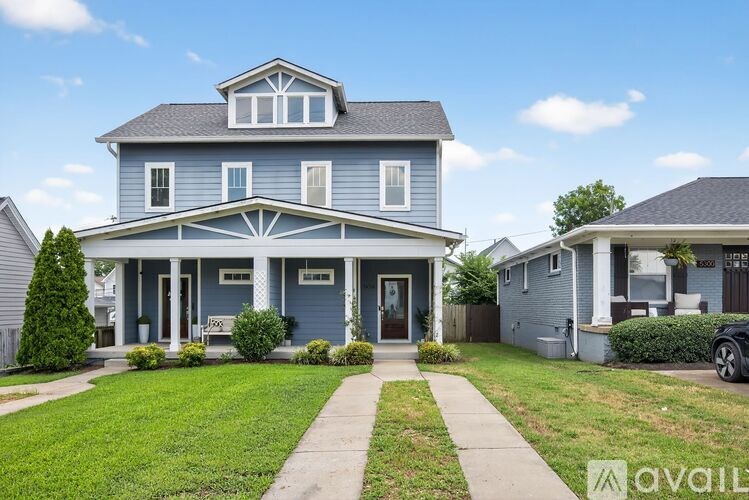 A blue house with a white trim and a sign that says "available" in the front yard.