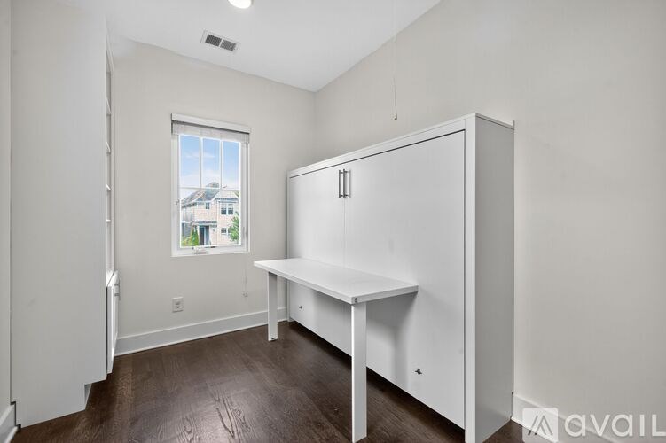 A white room with a table and a window.