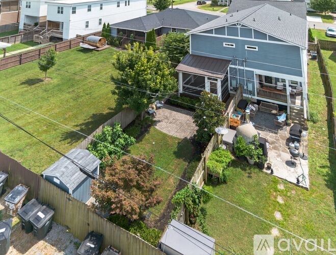 A house with a blue garage and a brown fence.