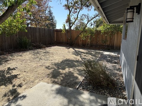 A motorcycle is parked in a garage with a door that has a number 1114 on it.