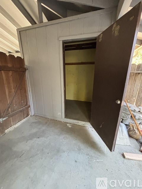 A room under construction with a door open to a wall.