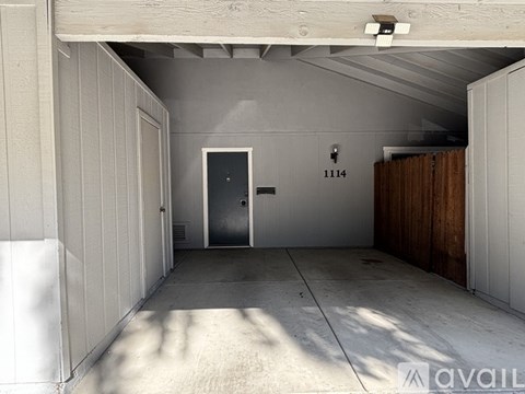 A room with a door and a wall number 1114.