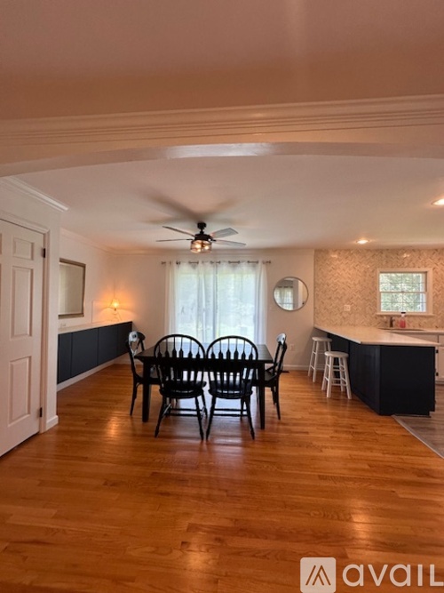 A dining room with a table set for four.
