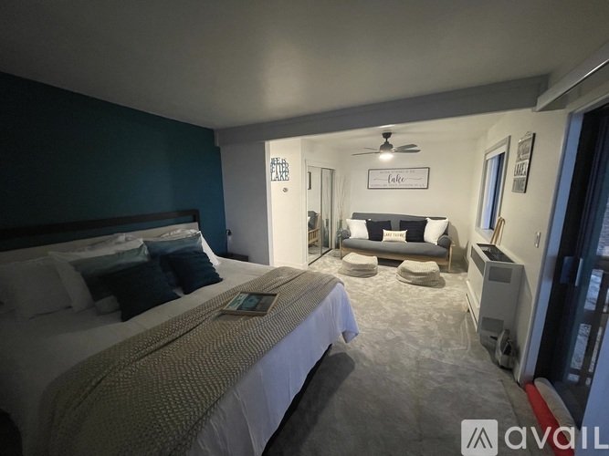 A bedroom with two beds and a couch in the corner.