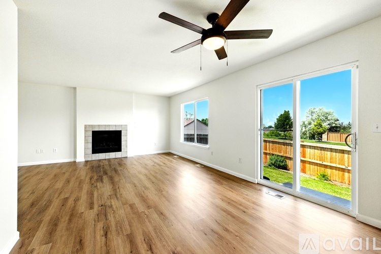 A spacious living room with a fireplace and sliding glass doors.