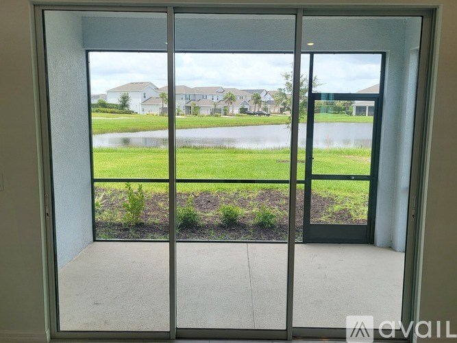 A view of a residential area through a sliding glass door.