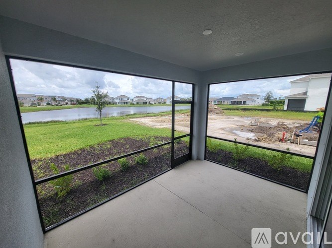 A balcony with a view of a lake and houses.