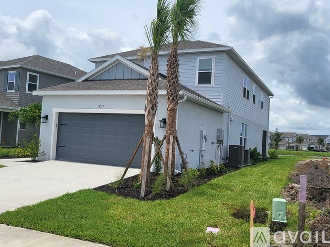 A house with a palm tree in front of it.