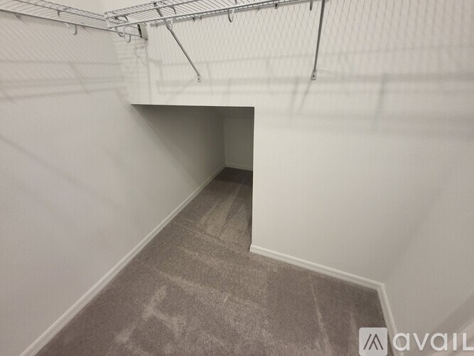 A room with a carpeted floor and a white wall.