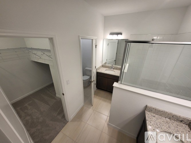 A bathroom with a walk-in shower and a toilet.