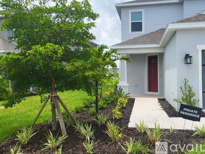 A white house with a red door and a sign that says "Private Residence".