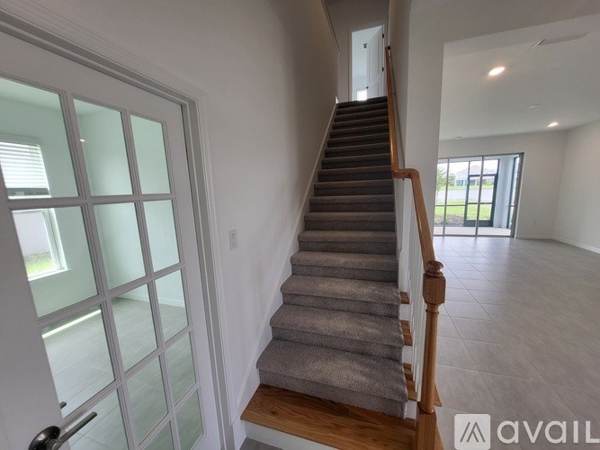 A staircase with a carpeted runner and wooden banister.